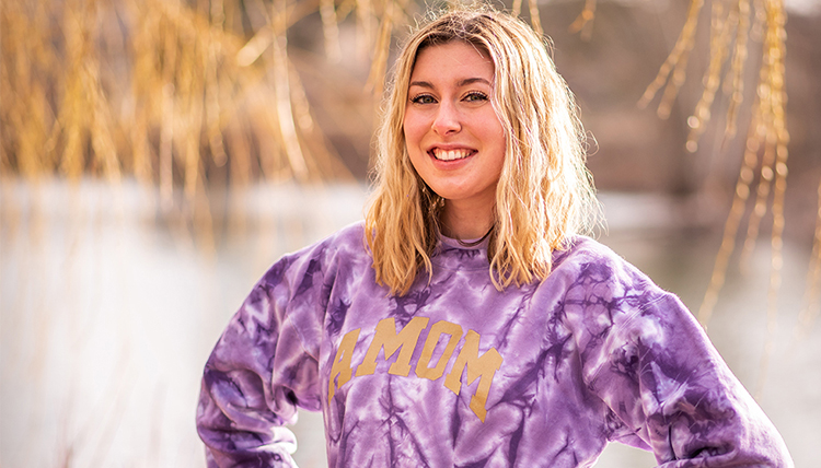 young woman in purple with blonde hair