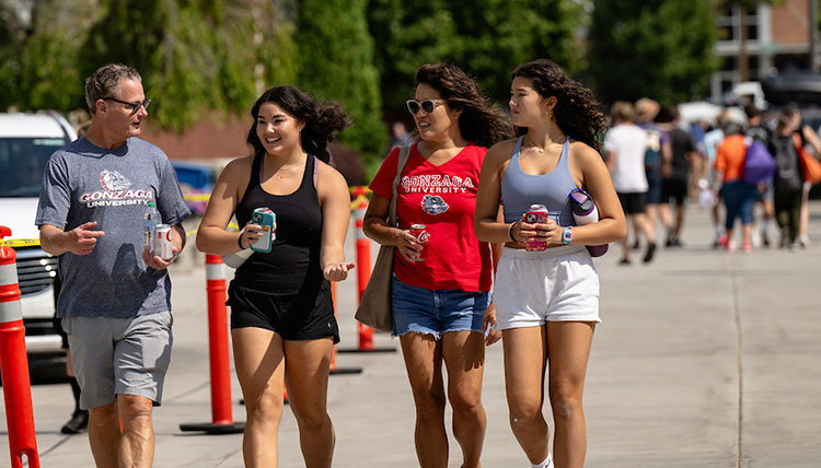 A family walks on Bulldog Alley