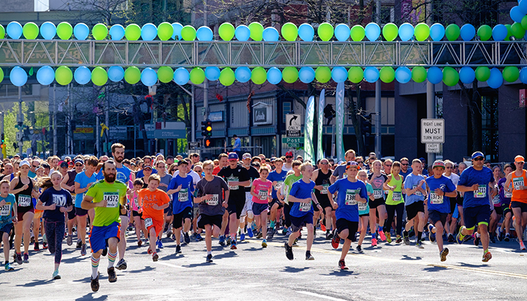A group of runners take off from the starting line at Bloomsday.