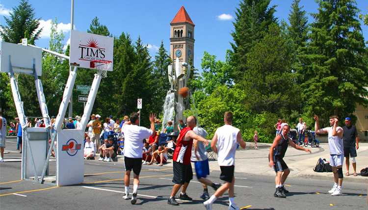 Players look to score a basket in a basketball game in downtown Spokane during Hoopfest.