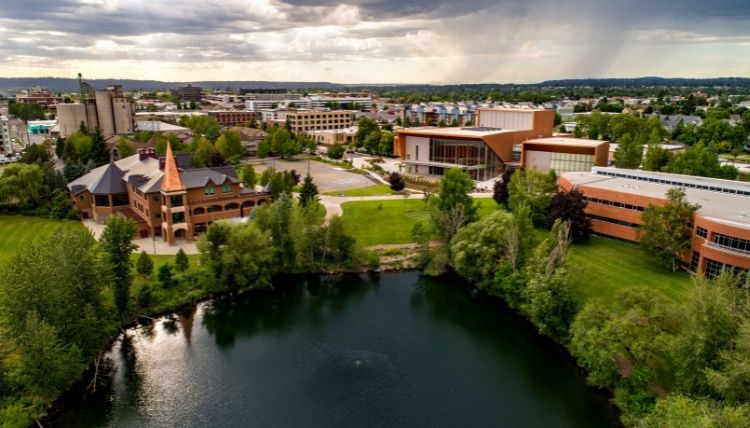 A drone shot of campus, showing Lake Arthur in the bottom. Jundt Art Museum, Myrtle Woldson Performing Arts Center, and Jepson Center can be seen.