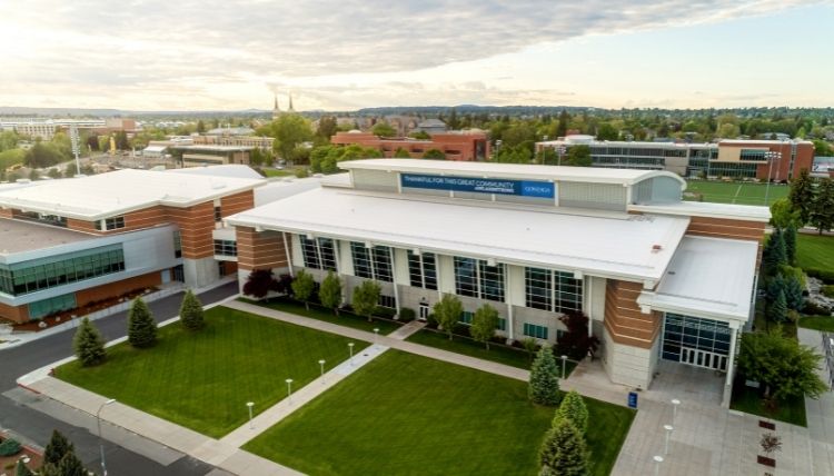 Drone shot of the back exterior of McCarthey, home to Gonzaga's athletics. No people can be seen. There is a banner on the building that reads, 'THANKFUL FOR THIS GREAT COMMUNITY #INLANDSTRONG' with the Gonzaga logo.