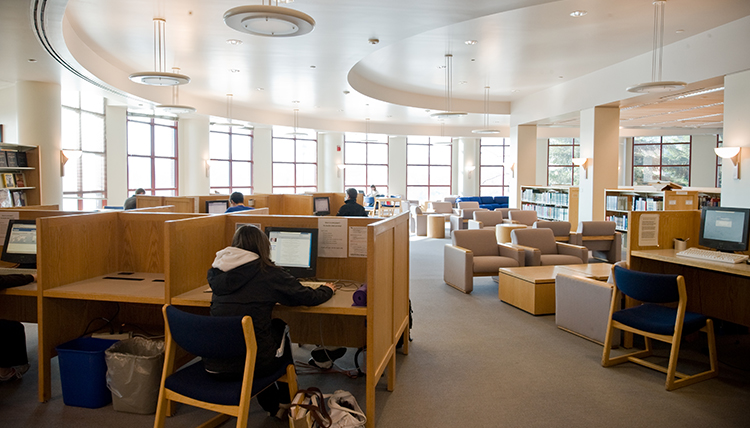 The first floor of Foley Library is shown, with study cubicles and chairs.