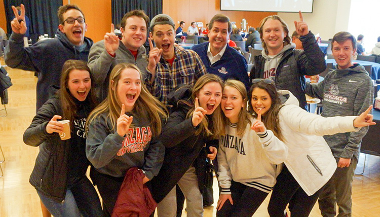 Gonzaga President Thayne M. McCulloh poses for a picture with students.