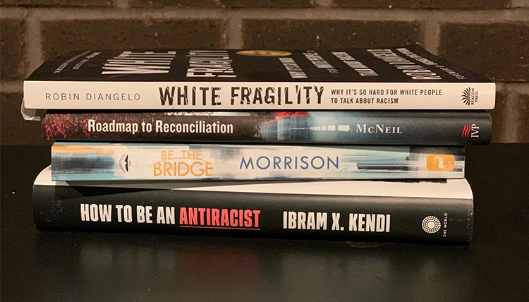 a stack of books about racism and white fragility