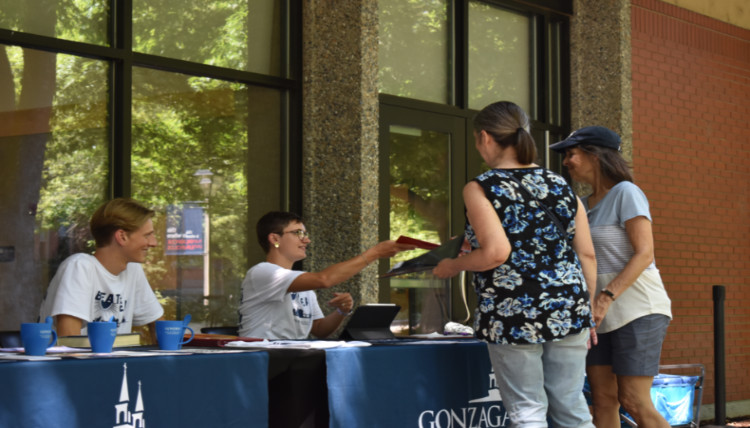 Climate Center staff and student workers check in a pair of volunteers for the evening route shift where they collected temperature and humidity data to create the Spokane heat maps