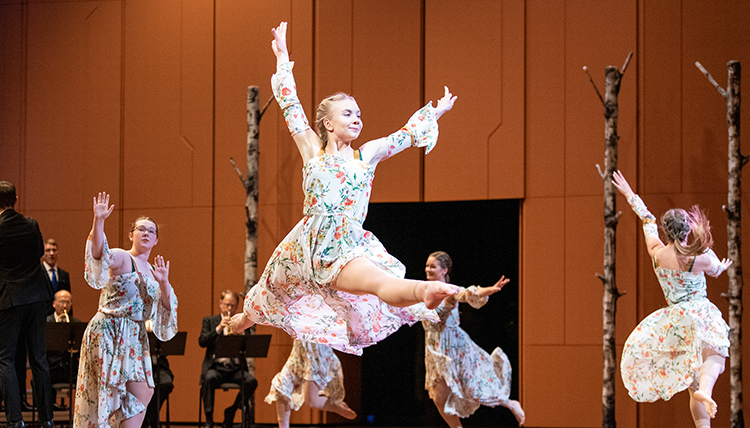 dancers leaping on stage at Woldson PAC