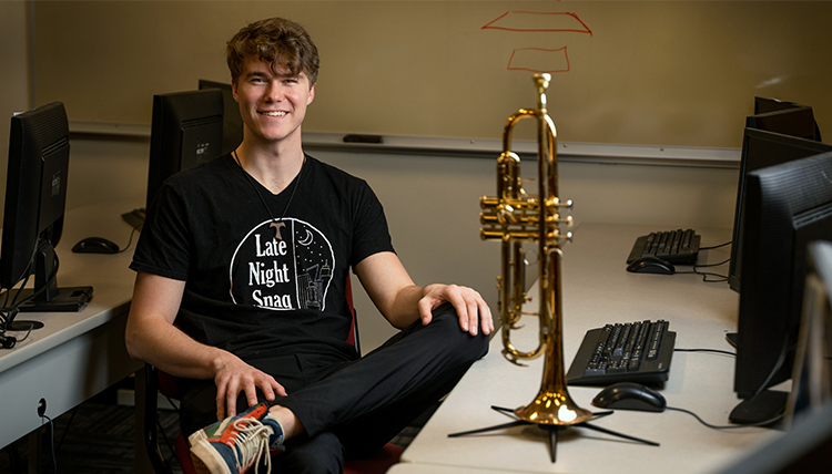 Michael Zell poses next to his instrument