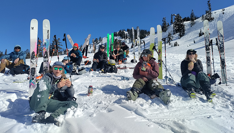 skiiers on a mountain take a break