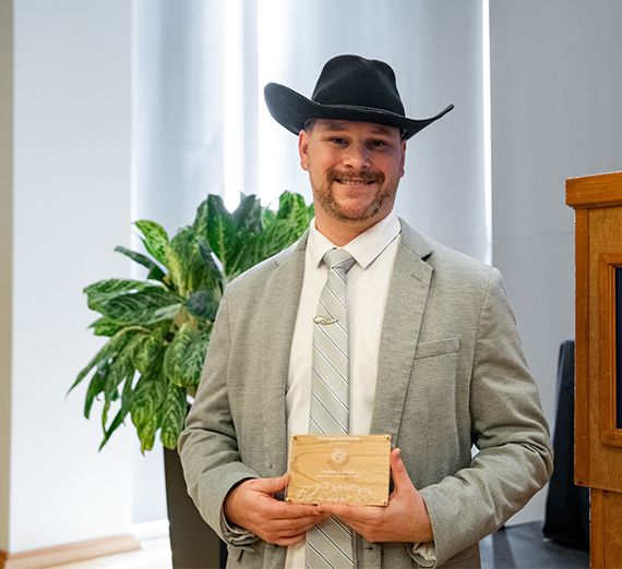 Holden Rupp smiling and holding the Jerome Nadal, S.J. Award at Gonzaga University's Magis Awards.