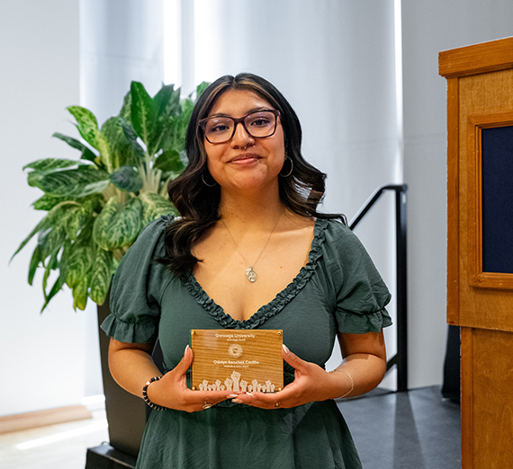 Odalys Sanchez Cedillo smiling and holding the Solidarity in Action Award at Gonzaga University's Magis Awards.