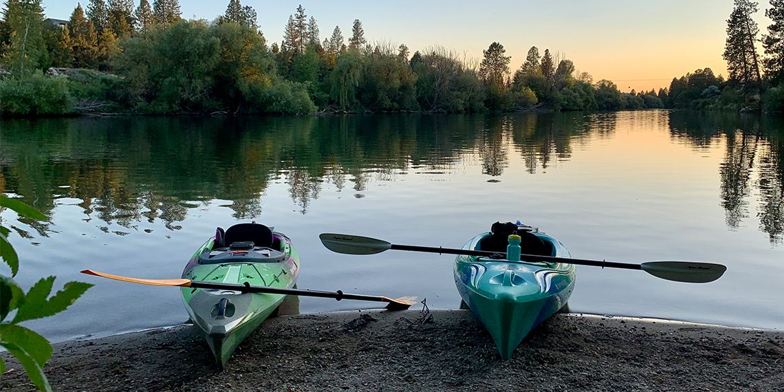 2 kayaks on the beach of the Spokane River at sunset
