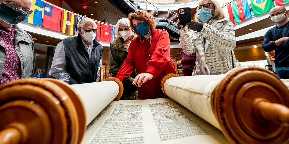 people look at the scrolls of the Torah