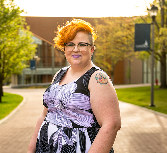 person in purple and black dress on campus