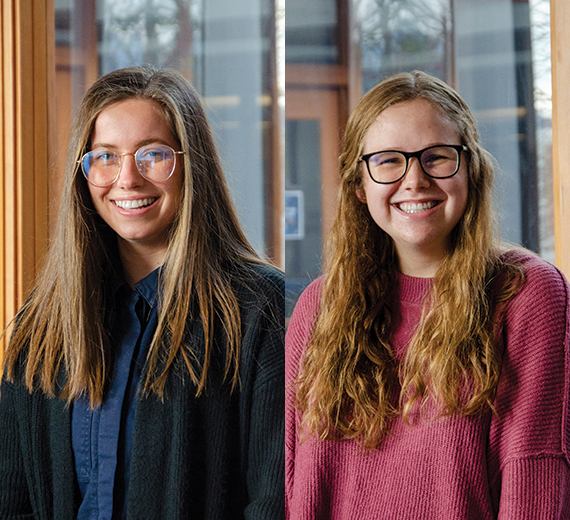 2 women, the college student on the left wears metal glasses and long straight brown hair. The college student on the right has light brown wavy hair with dark rimmed glasses. 