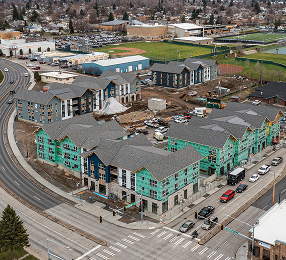 Drone photo fo the Gonzaga Family haven completing construction. 2 of the 4 building are complete with siding. the other 2 are built but are missing the finished siding. In the distance you can see the Gonzaga Prep baseball fields. 