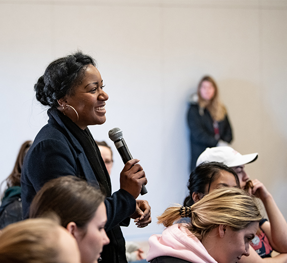 A guest asks a question at a panel discussion over MLK Weekend.