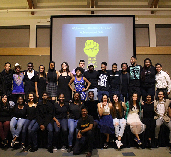 A group of students from the Black Student Union pose at an event. 