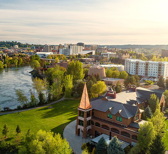 An aerial view of campus and the river on a summer evening.