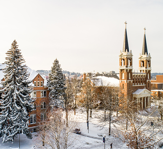 Sunshine and snow is shown on Gonzaga's campus and near St. Al's church.  