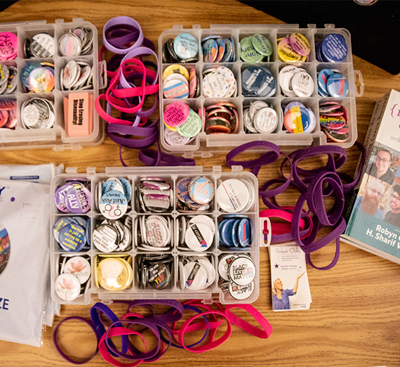 Plastic containers hold buttons, pins and wristbands that celebrate different gender identities.