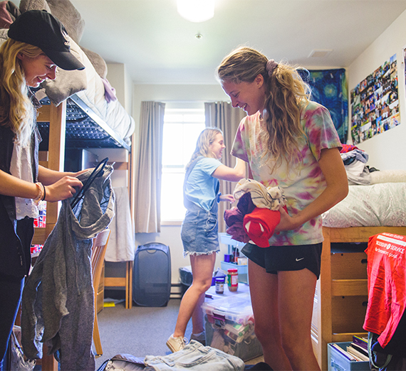 New roommates work to unpack their items during move-in weekend.  