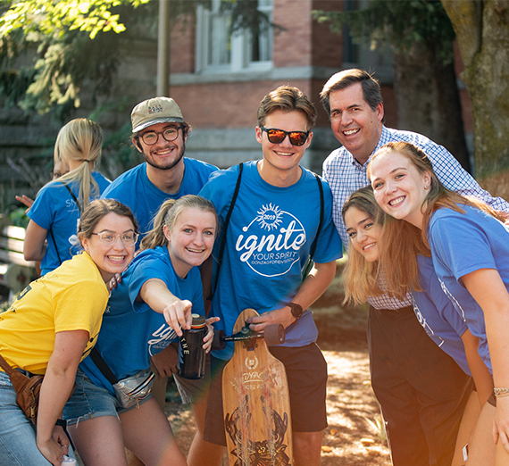A group of orientation leaders smiles and poses. 