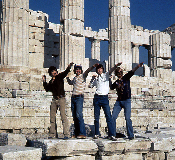 Four men - Joel DiGangi, Dan McLafferty, Tom Kearney, and Craig Sparrow - in Athens, Greece, posing at the base of the Parthenon in January 1976. 