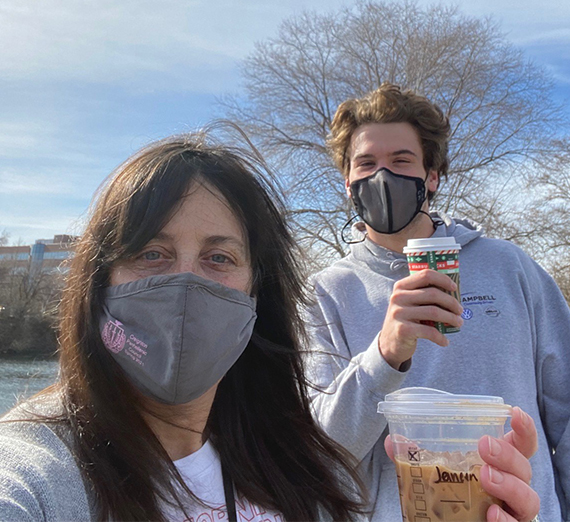 Kispert (right) poses with Steer (left) both holding cups of coffee