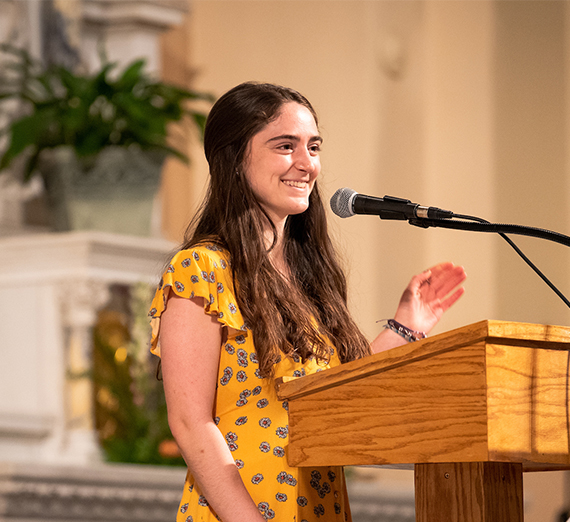 female student smiling from podium