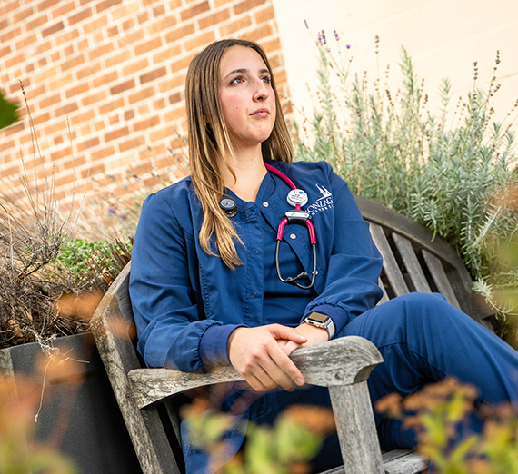 female student in scrubs with stethoscope