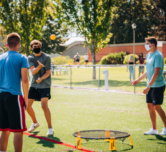 Students in masks playing on Mulligan