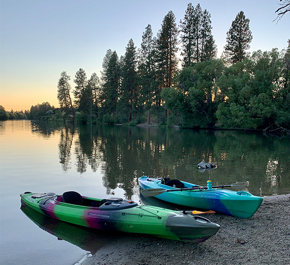 2 kayaks on the beach of the Spokane River at sunset 