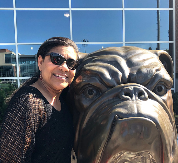 Maddie Collins posing with Spike the Bulldogs 