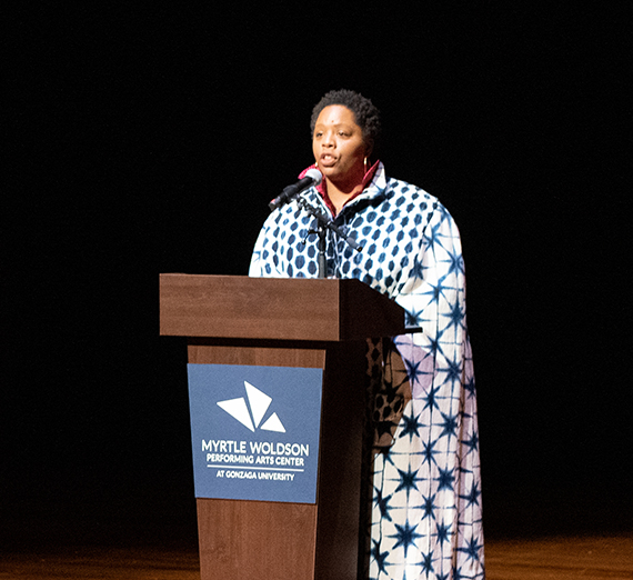 Woman speaking behind a podium onstage at the Myrtle Woldson Performing Arts Center