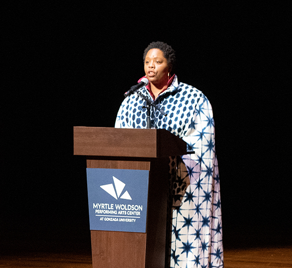 Woman speaking behind a podium onstage at the Myrtle Woldson Performing Arts Center 