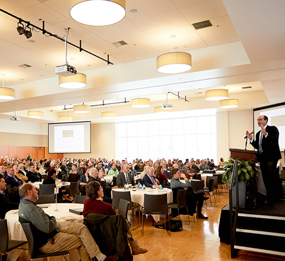 View of attendees in auditorium with Dr. Don Hilton at podium. (From front of room).