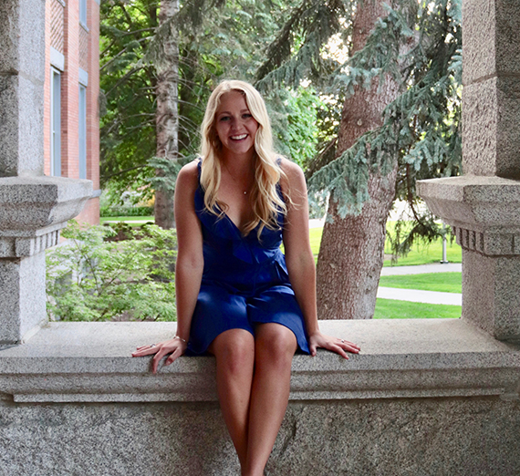 Oakley Wurzweiler smiling in front of a bridge and river.