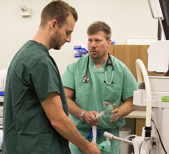 Dr. Geoff Jones, M.D., right, gives guidance