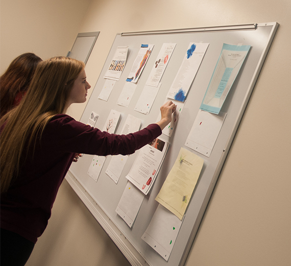 students reviewing materials on a white board