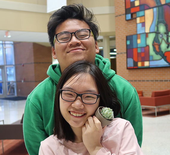 two vietnamese students embrace