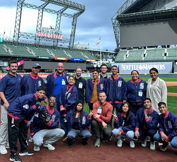 A group of Gonzaga students and visitors from Ecuador gather in the Seattle Mariners' baseball stadium