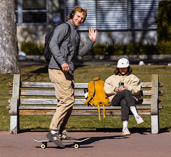 A student skateboards on campus