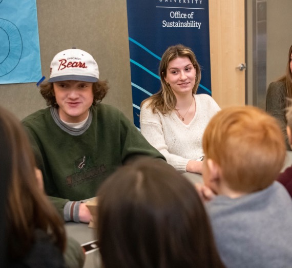 Students weave young pine boughs
