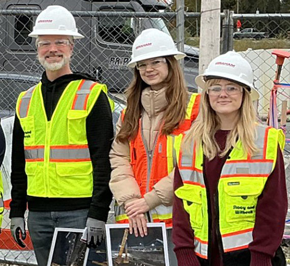 Three people on construction site
