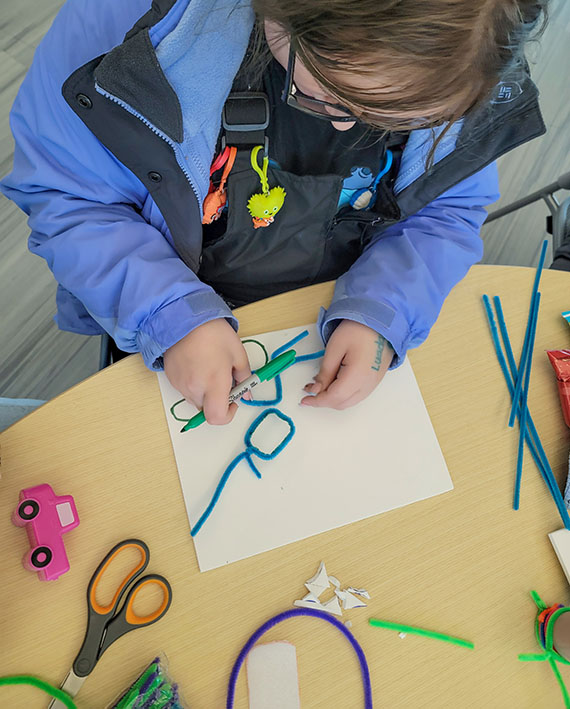 Child with craft pipe cleaners