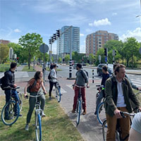 A group of students on bikes waiting for others to catch up.