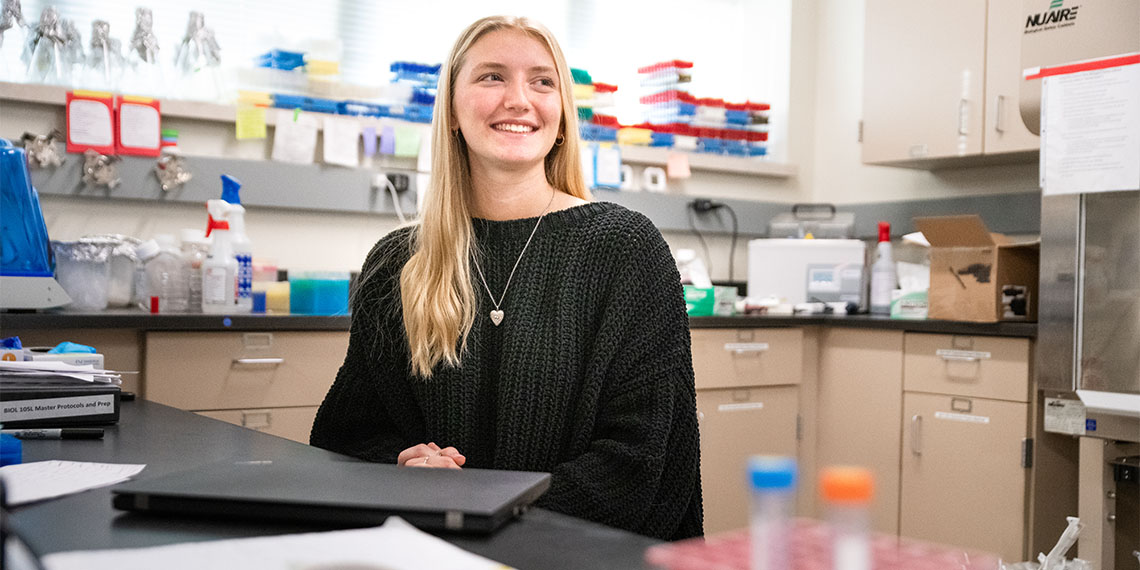 Brenna Messner sitting in a nursing lab looking away from the camera. 