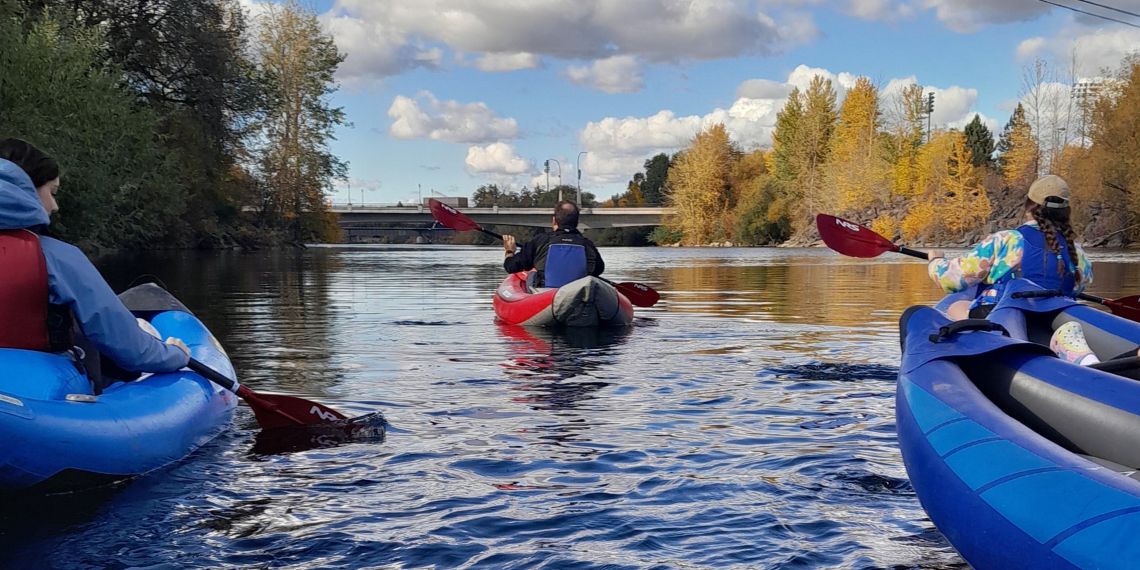 Students kayak down the Spokane river.