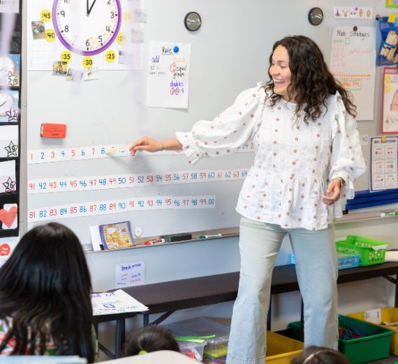Student teacher Halle Aparicio leads a math lesson with confidence and clarity, engaging young learners through interactive instruction and a warm classroom presence.